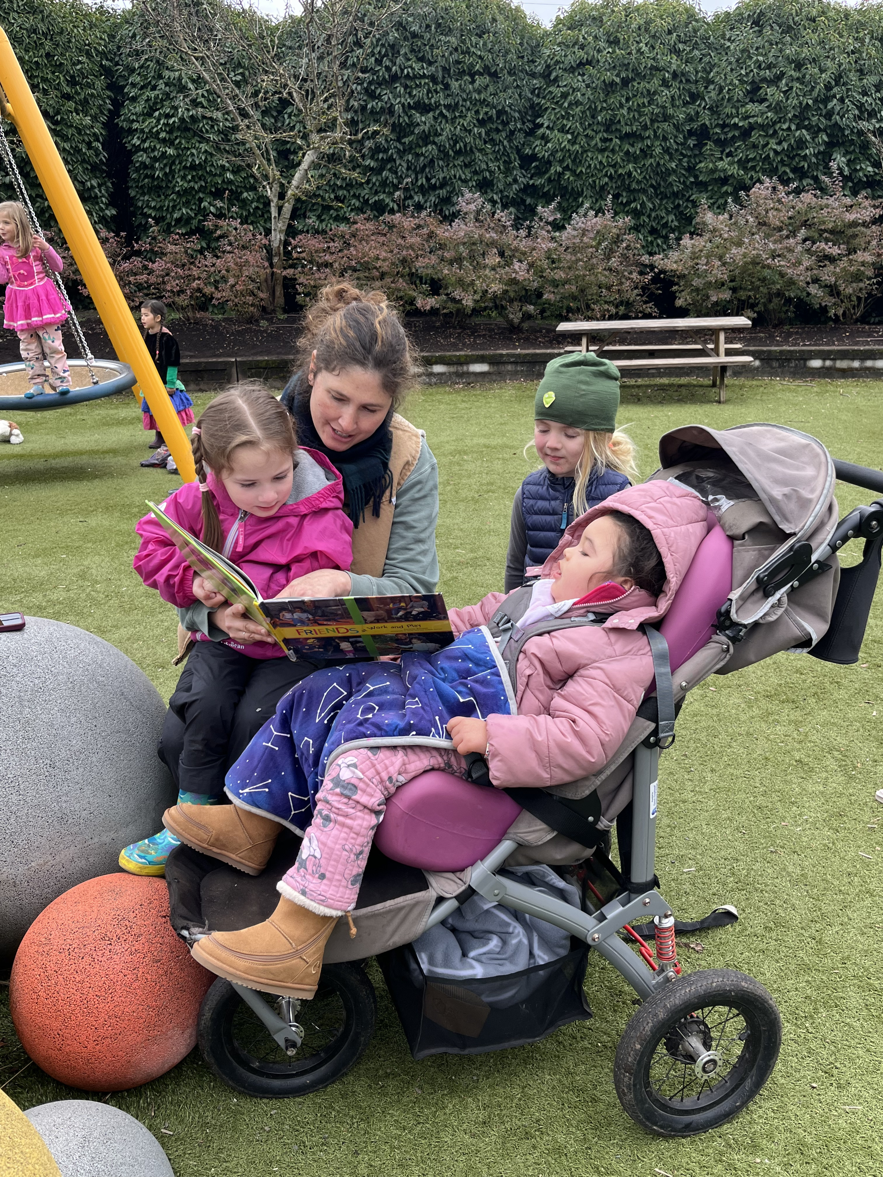 teacher and students reading outside